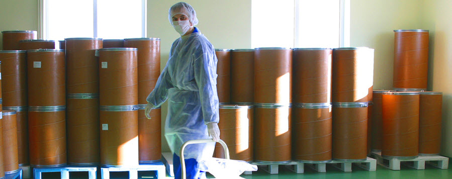 worker with chemical drums