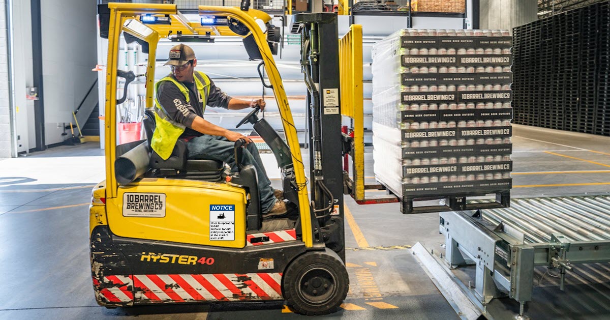 Worker operating a forklift safely