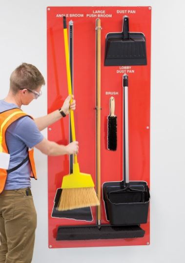 worker returning tools to a shadow board