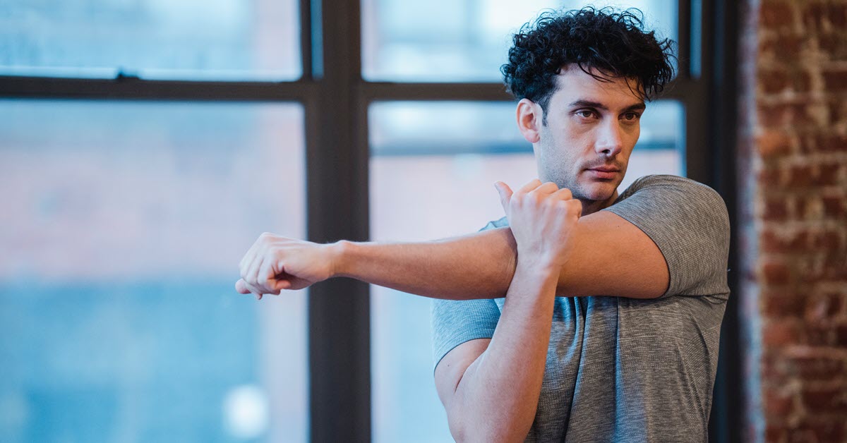 Worker stretching arms to prevent repetitive stress injuries