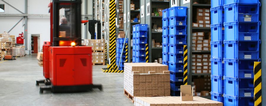 workers using forklift in warehouse