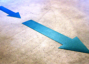 Blue directional arrows labels on a warehouse floor